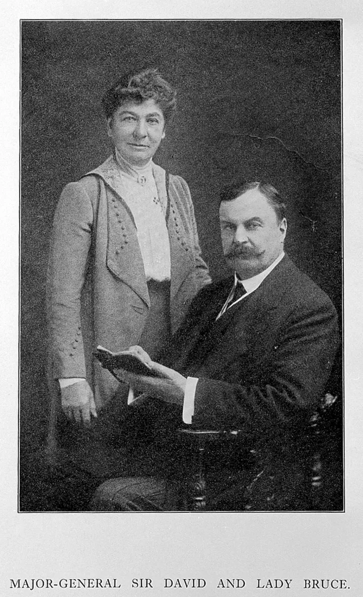 A formal studio portrait of Major-General Sir David Bruce seated with Lady (Mary) Bruce standing beside him, taken after his 1908 knighthood.